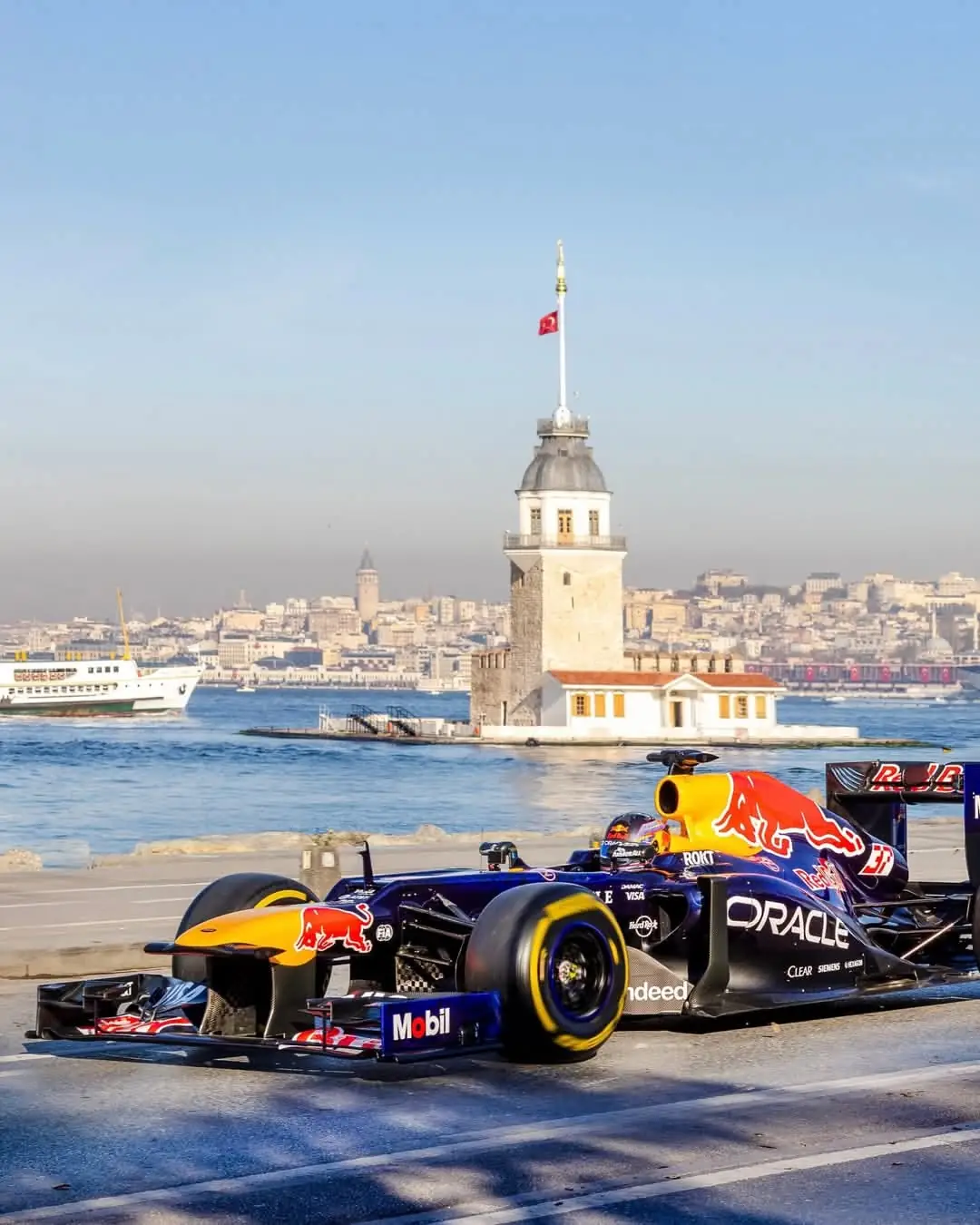 A Formula 1 car on the Bosphorus shore in Istanbul, with the Maiden's Tower behind